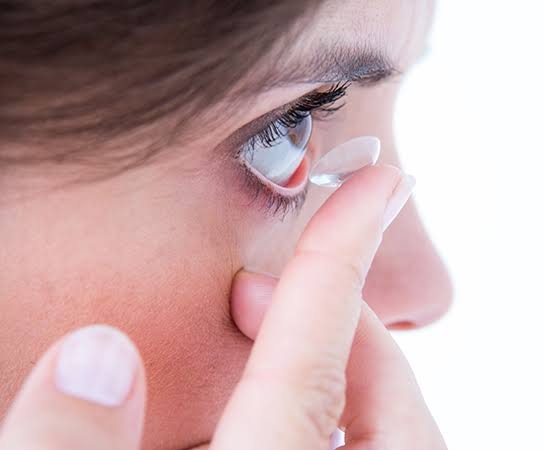 Mujer poniéndose un lente de contacto
